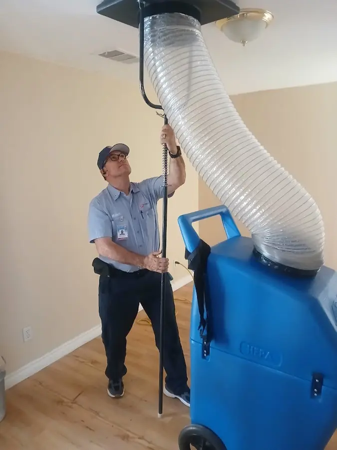 Furnace Tune-Up technician using HEPA equipment in Littleton